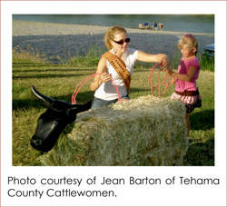 A woman handing a child a rope